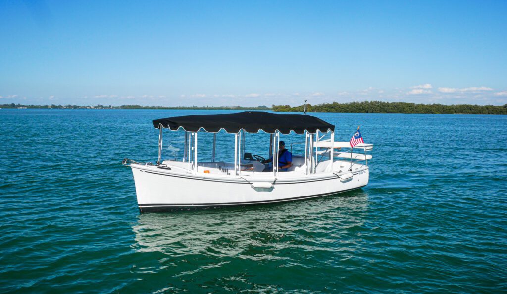 a man seating in the boat with a flag on it
